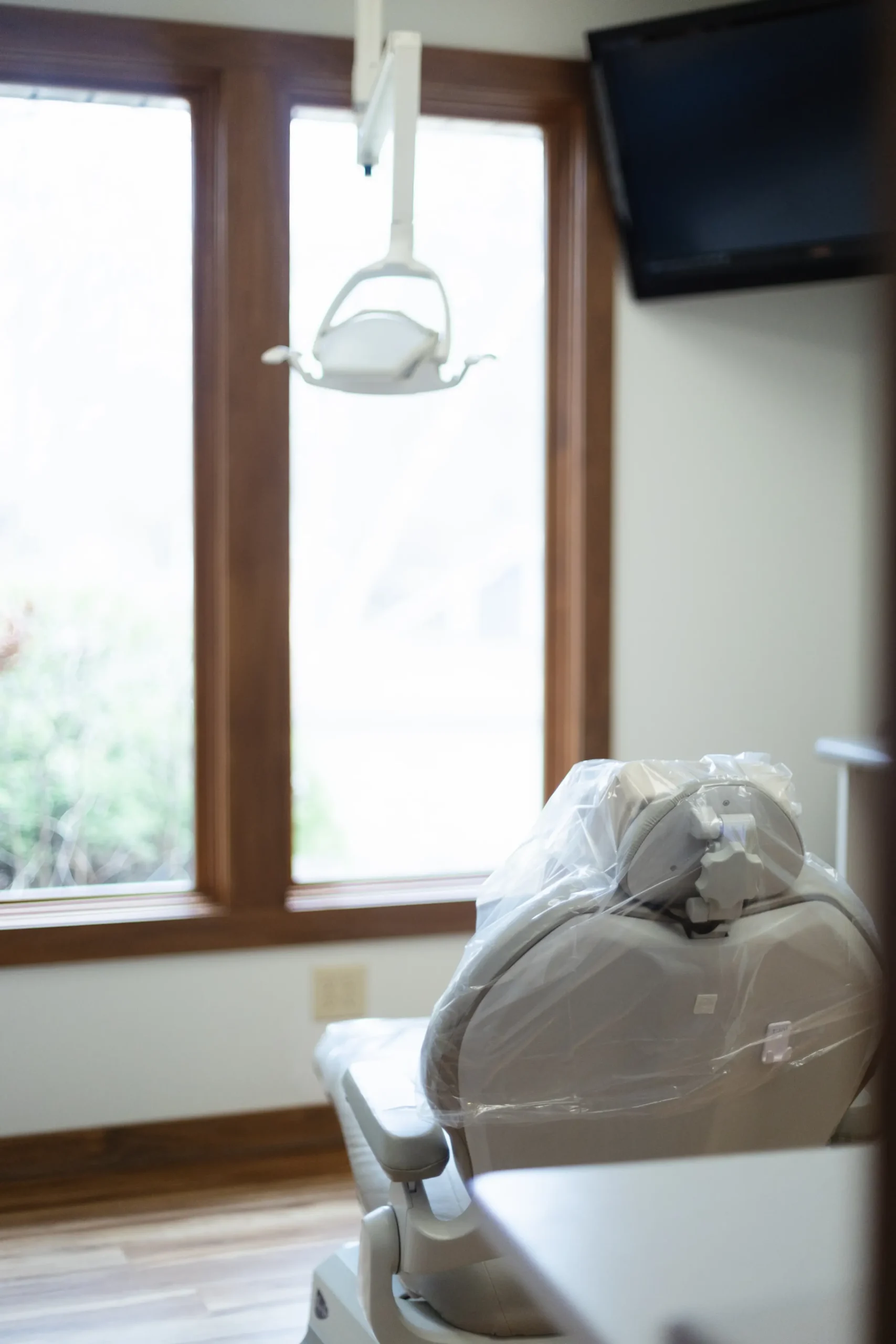 a bright dental office showing the back of a dentist chair