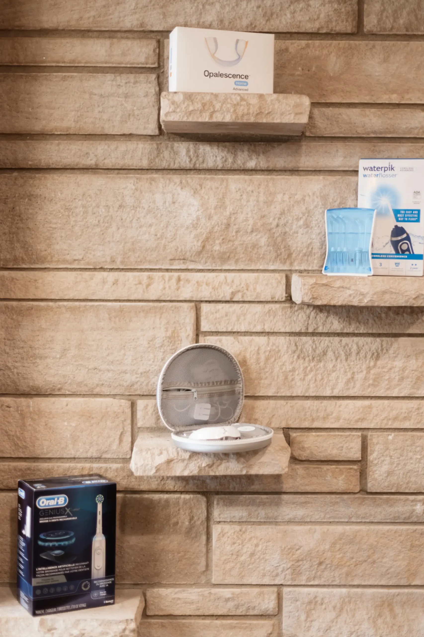 A brick wall with shelves with clear aligners
